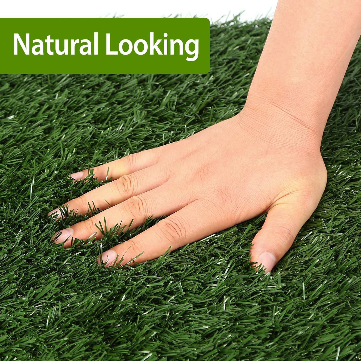 Hand pressing lush artificial grass turf showing realistic soft texture