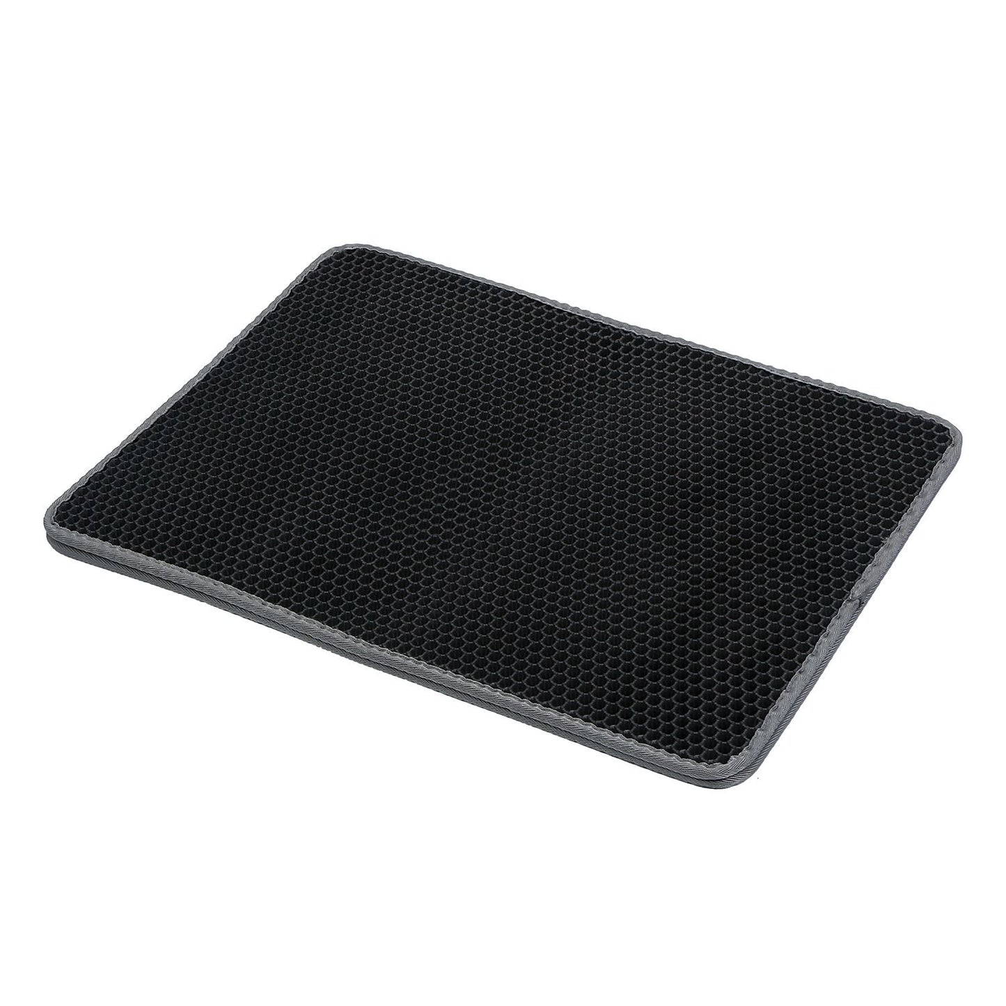 angled view of honeycomb litter mat showing textured surface, raised cells, and gray stitched edge