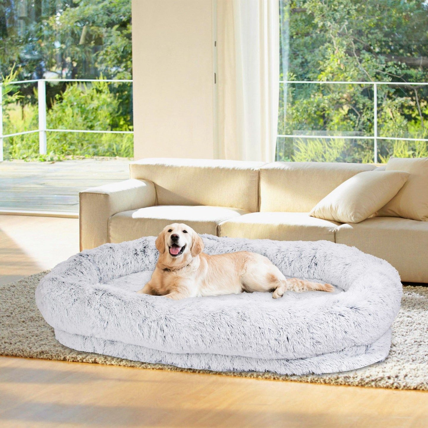 Golden retriever resting on grey fluffy human-size dog bed in living room