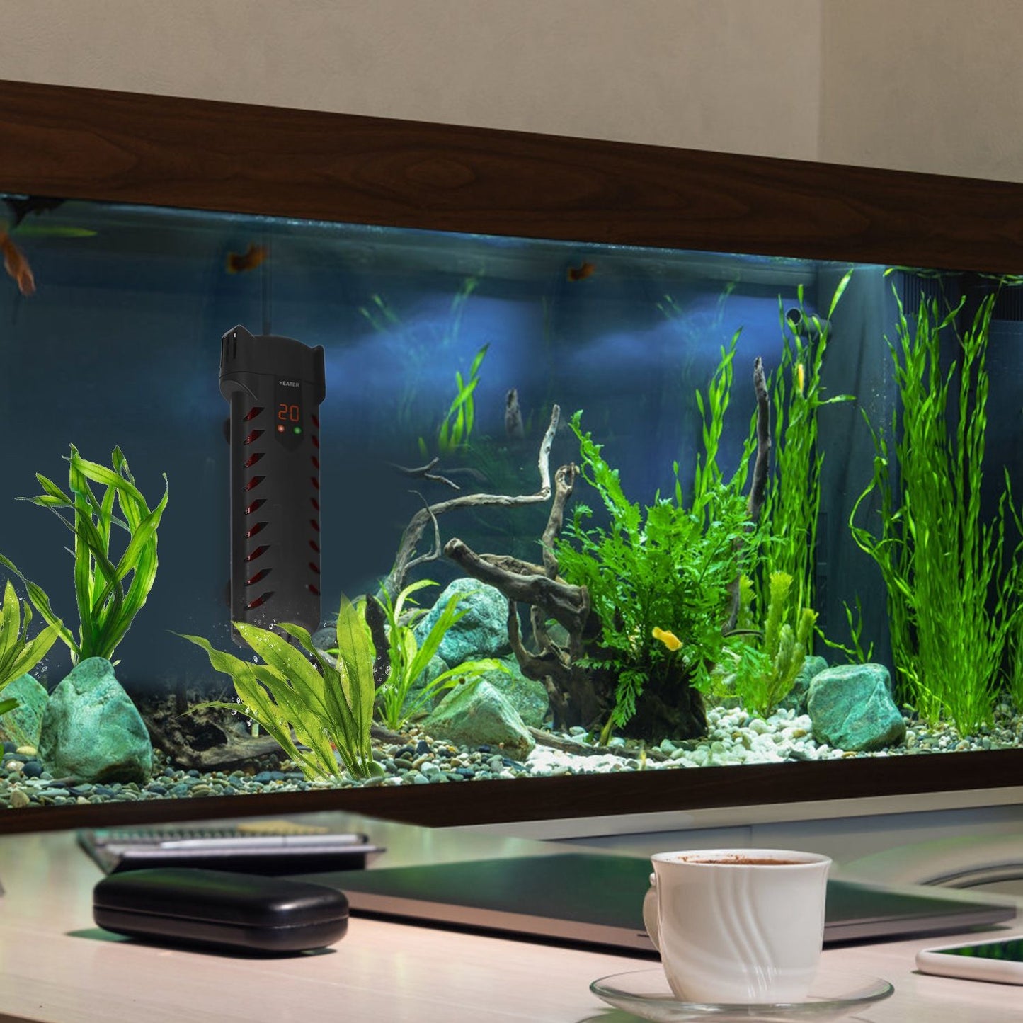 Heater mounted inside a planted desktop aquarium on a desk beside office items