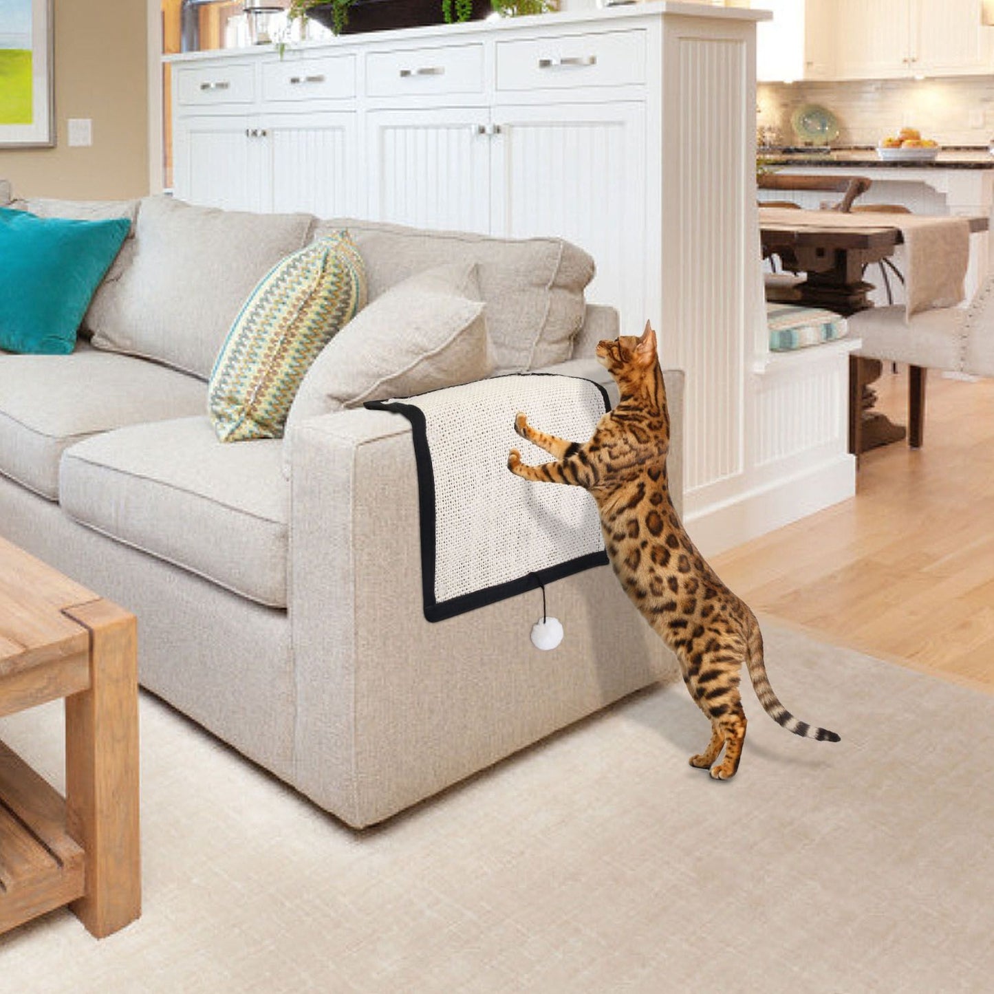 Sisal scratching mat draped over sofa arm protecting upholstery while cat scratches.