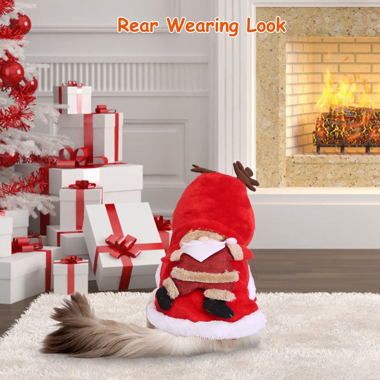 Dog in red coat with antlers and Santa appliqué sits near gifts and a fireplace