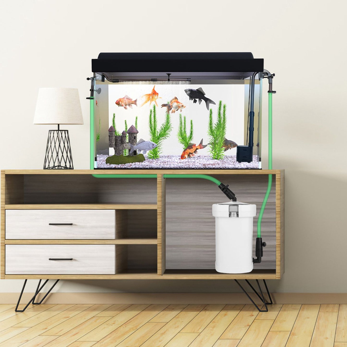 Aquarium on cabinet with hoses routed through furniture to canister filter hidden inside cabinet