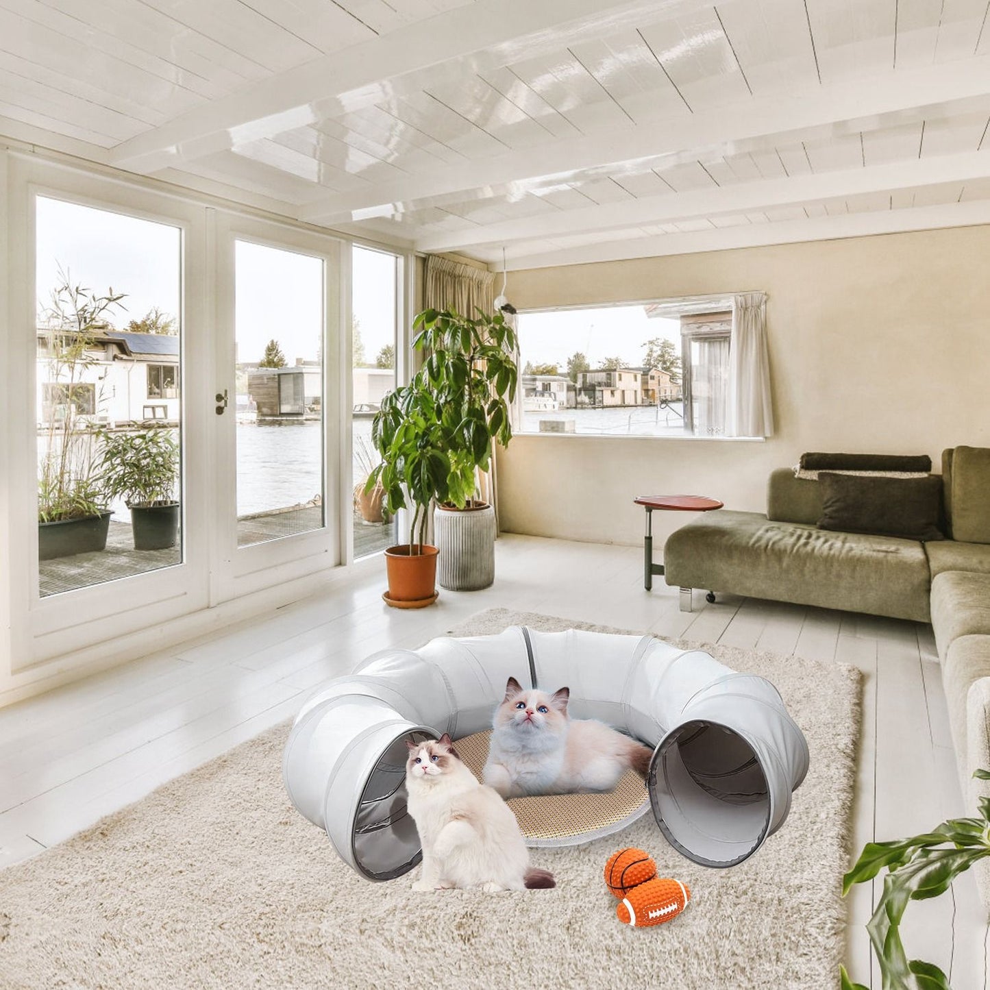 grey cat tunnel bed on living room rug with two cats and pet toys, staged for home use