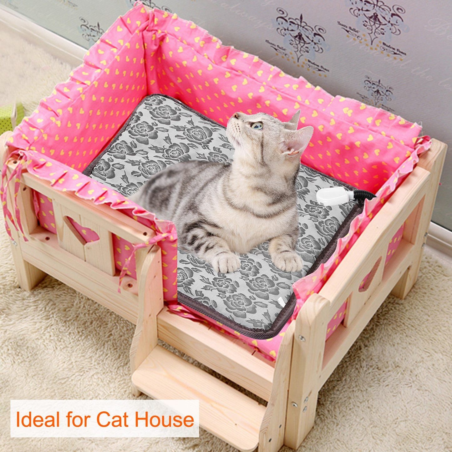 Cat resting on floral heating pad inside a wooden cat bed to show fit and use