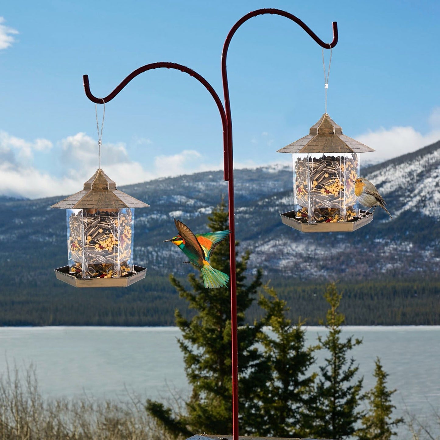 Two hanging gazebo bird feeders on a double-hook pole by a lake and mountains