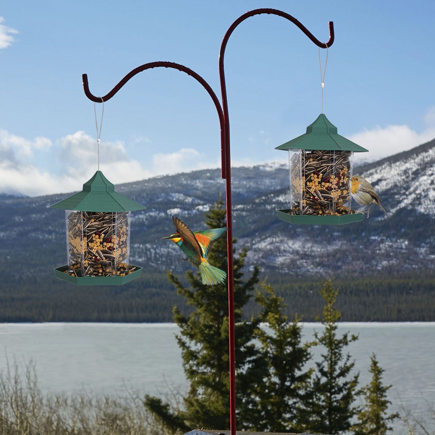 Two feeders hanging on a garden stake by a lake and mountains to show outdoor placement