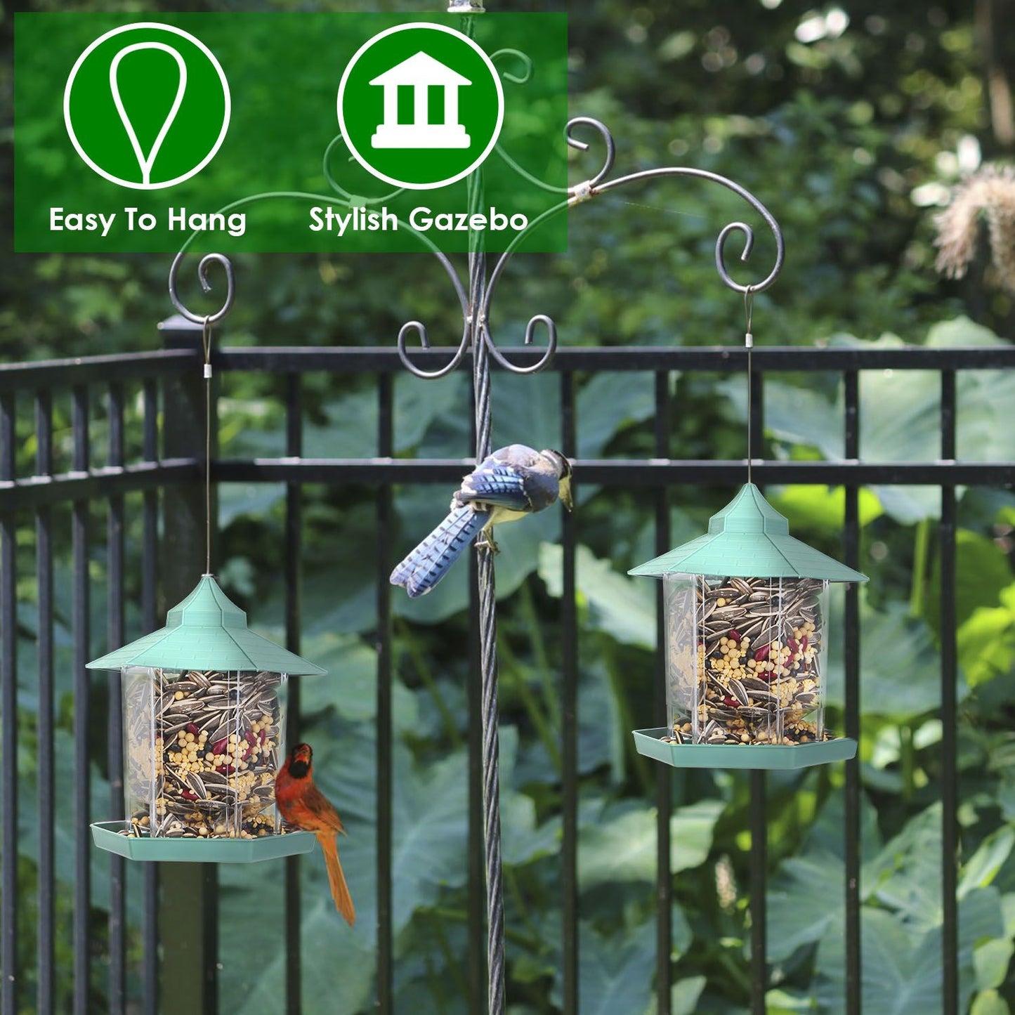 Two gazebo bird feeders hanging from hooks on a patio railing with birds nearby