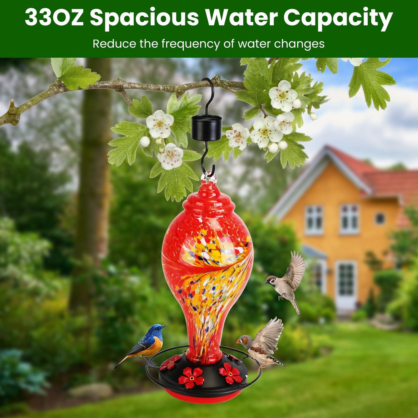Red feeder hanging from branch in garden scene illustrating 33oz water capacity