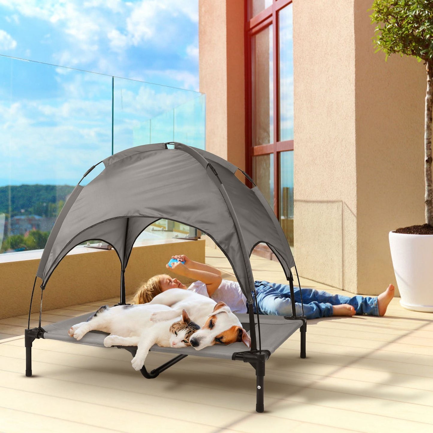 Elevated grey pet bed with canopy on a balcony used by a dog and cat for outdoor lounging