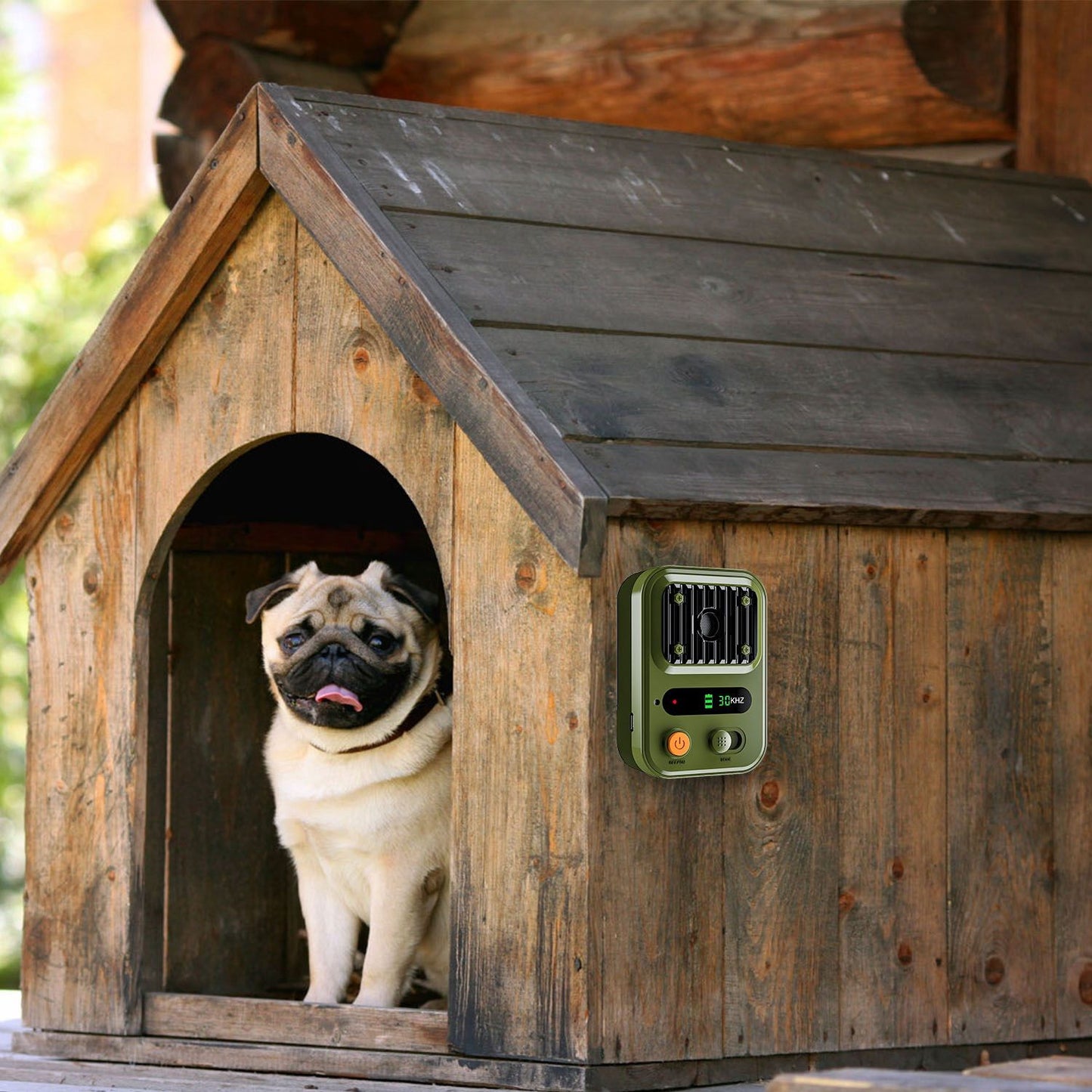 Anti-bark device mounted on dog house exterior next to a resting dog