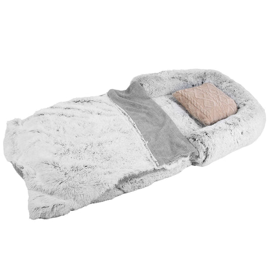 Grey fluffy foldable human-sized dog bed laid flat with blanket and pillow