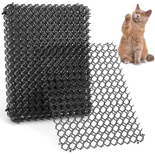 Stack of black hexagonal spike mats shown with a cat nearby for scale