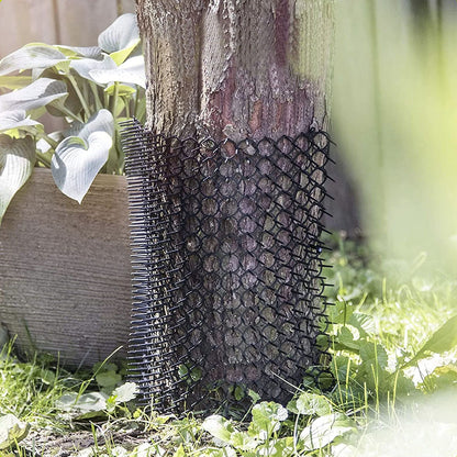 Spike mat wrapped around a tree trunk to prevent animals from climbing