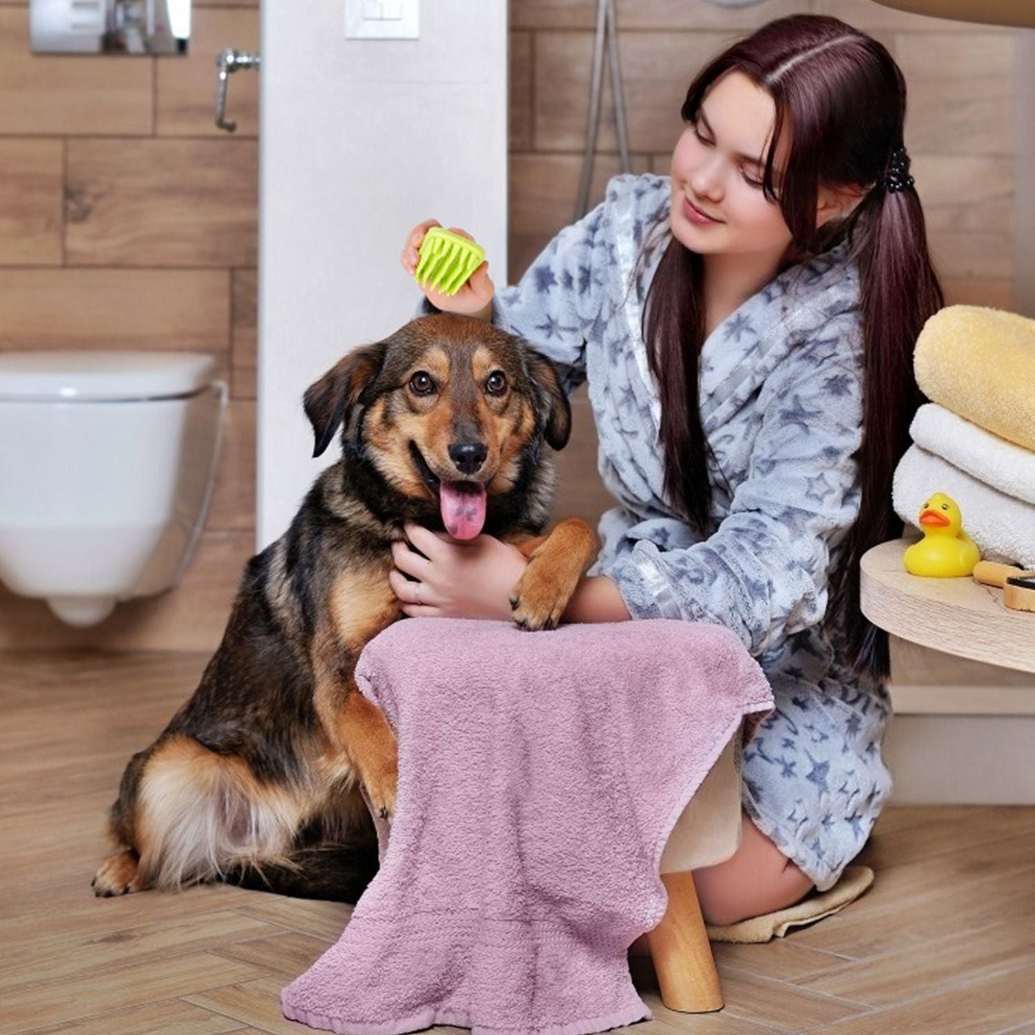 Person using the silicone pet brush to groom a seated dog in a bathroom setting