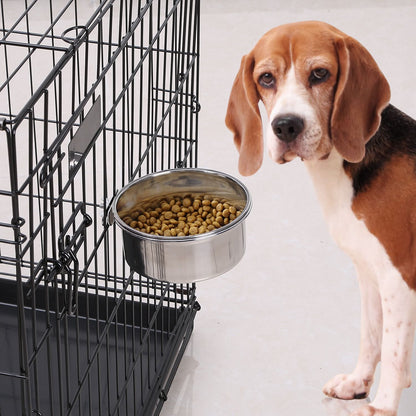Hanging stainless steel bowl clamped to a wire pet crate filled with kibble