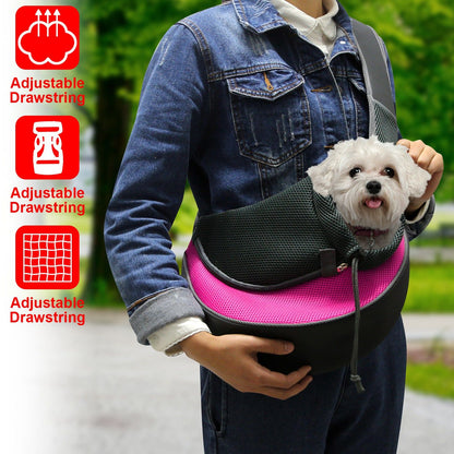 person wearing pink pet sling carrier with small dog held at chest