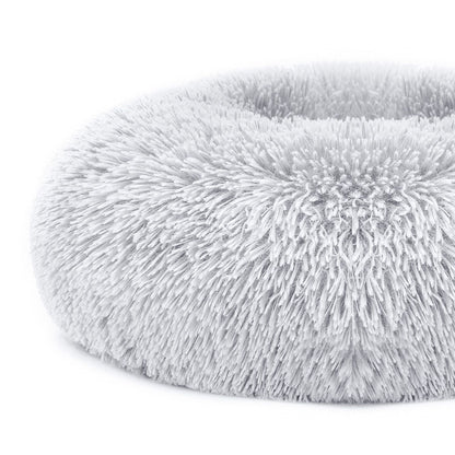 Close-up of grey bed edge showing dense plush fibers and rounded bolstered rim