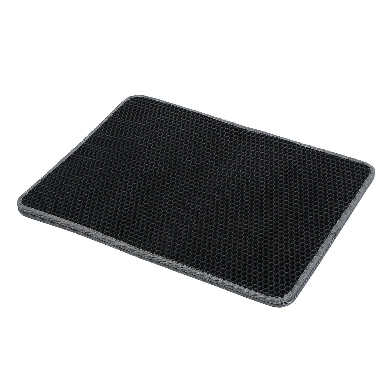 angled view of honeycomb litter mat showing textured surface, raised cells, and gray stitched edge
