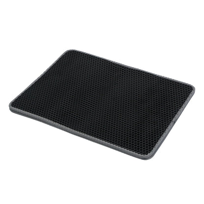 angled view of honeycomb litter mat showing textured surface, raised cells, and gray stitched edge