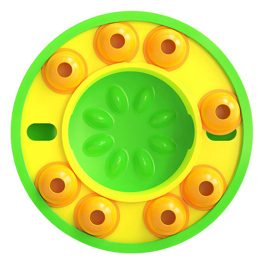 Top-down view of green and yellow slow-feed puzzle bowl with eight orange rotating granaries