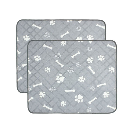 Two grey quilted reusable pet pee pads with white paw print and bone pattern stacked