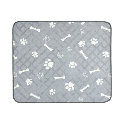 Flat grey quilted pet pee pad with white paw prints and bones shown against white background