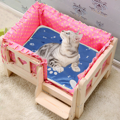 Cat resting on heated pad inside a wooden pet bed with pink lining, pad fits snugly