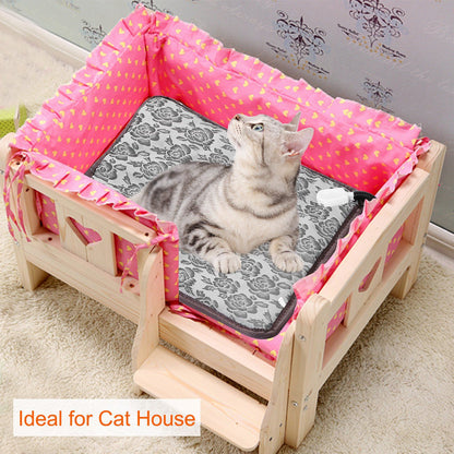 Cat resting on floral heating pad inside a wooden cat house