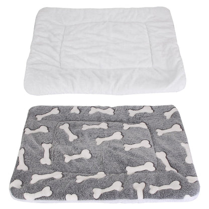 Two views showing white fluffy underside and grey bone-patterned top of the reversible pet mat