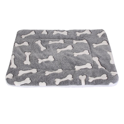 Top view of grey dog mat with white bone prints showing rectangular shape and stitched perimeter