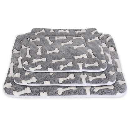 Three grey bone-pattern mats stacked to illustrate available M L XL size range