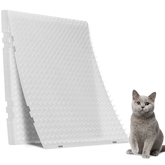 Stacked transparent spiked cat deterrent mats with a grey cat beside them