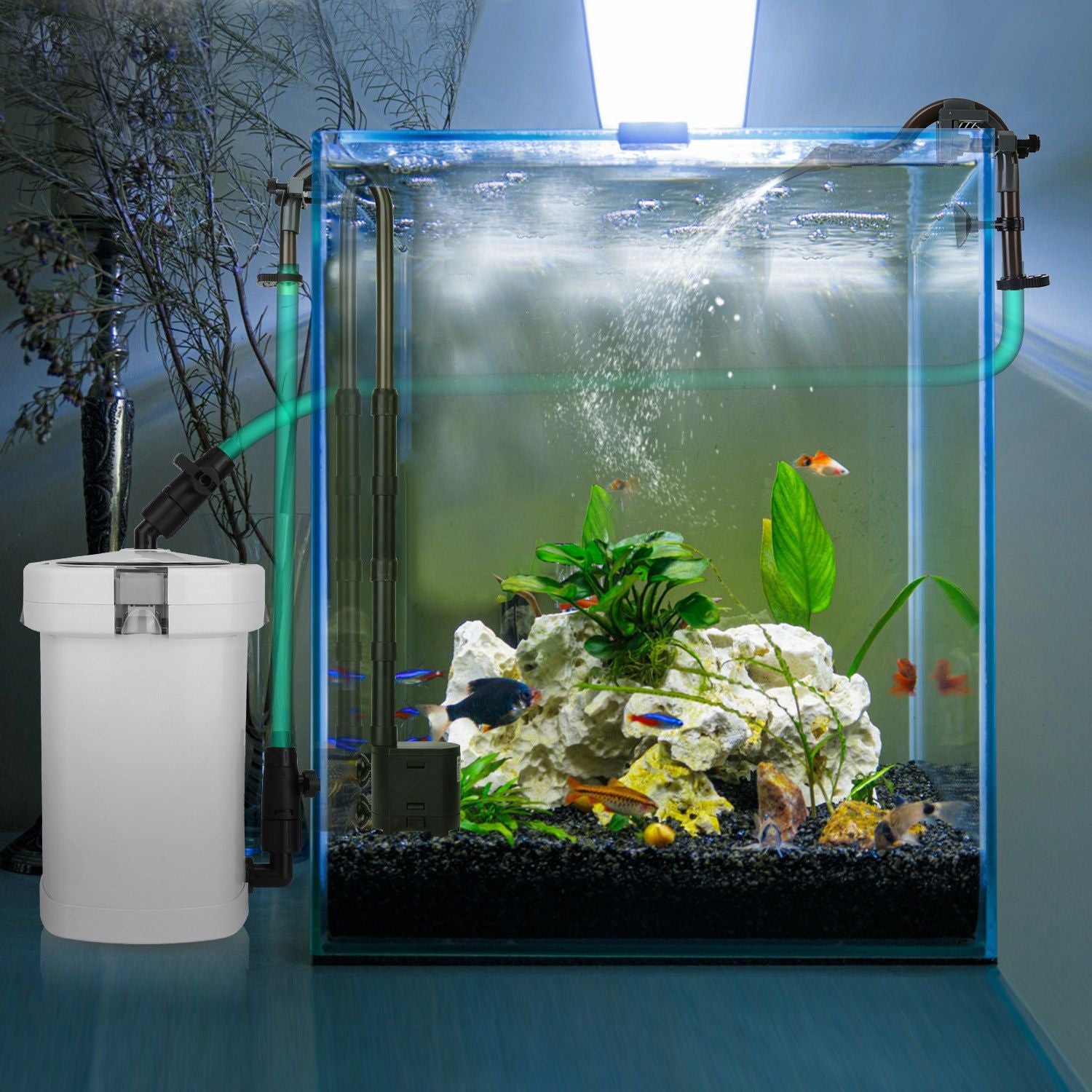 Canister filter installed beside a planted aquarium with hoses and water return creating surface flow