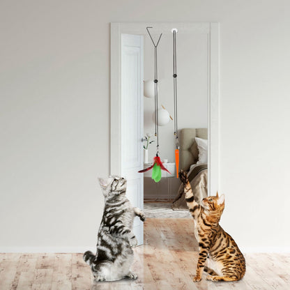 Two cats reaching up to hanging feather and worm toys suspended from a doorway clip and suction-mounted line