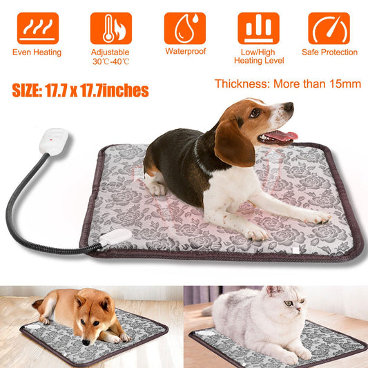 Gray floral 17.7 x 17.7in pet heating pad with cord and controller and a dog lying on it