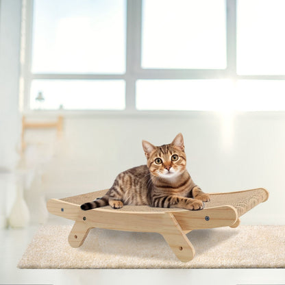 Tabby cat resting on horizontal wooden scratcher on a rug in a bright room