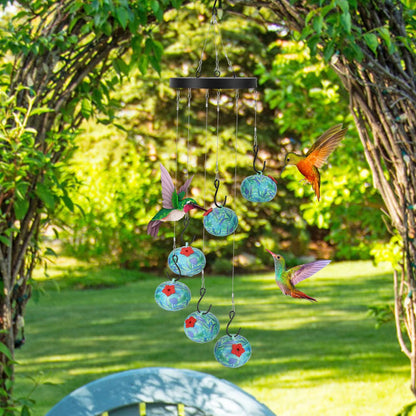 hummingbird feeder hanging under a garden arch surrounded by greenery and hummingbirds