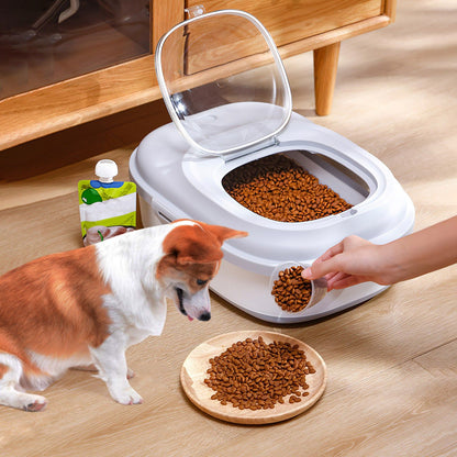 Person scooping dog kibble from open collapsible container while dog watches