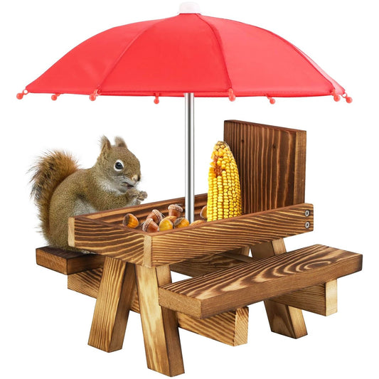 Wooden squirrel feeder picnic table with red umbrella, corn and nuts and squirrel perched on bench