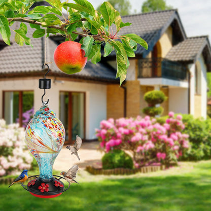 Blue feeder shown hanging beside walking couple in an outdoor park scene