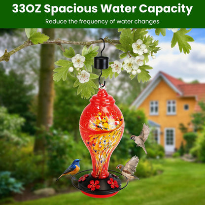 Red feeder hanging from branch in garden scene illustrating 33oz water capacity