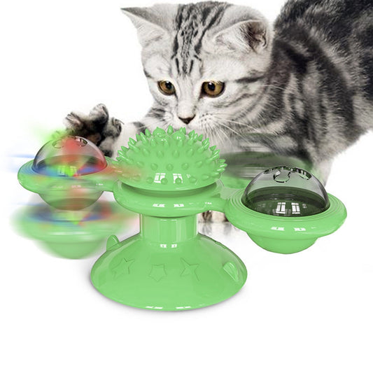green windmill cat toy with spiky center two transparent bins and suction base with kitten