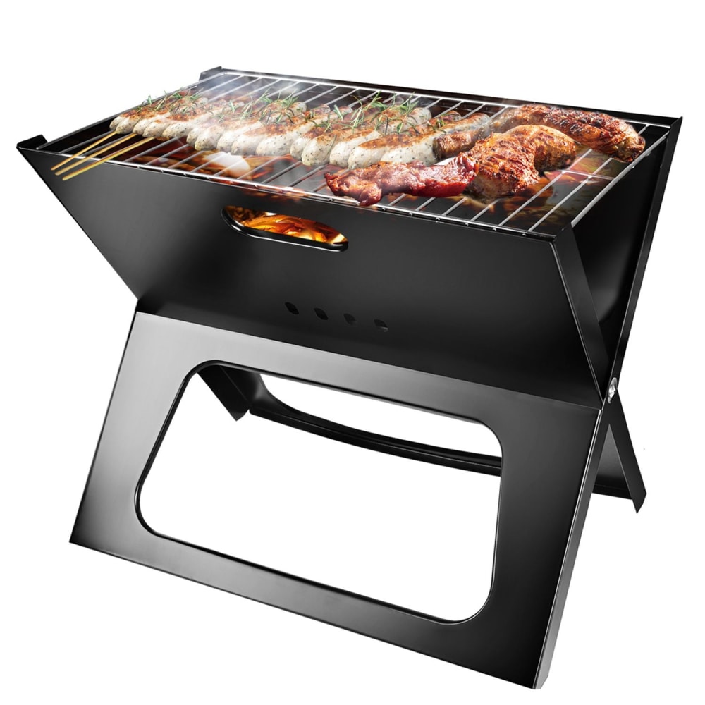 Portable black charcoal grill with meats and vegetables grilling, emitting smoke. Perfect for outdoor cooking and barbecues.