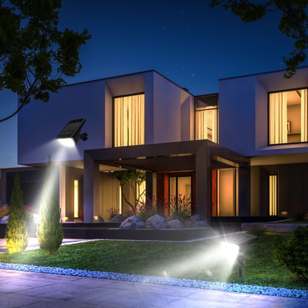 Modern home exterior illuminated at night with stylish solar garden lights highlighting the landscaped yard and entrance.