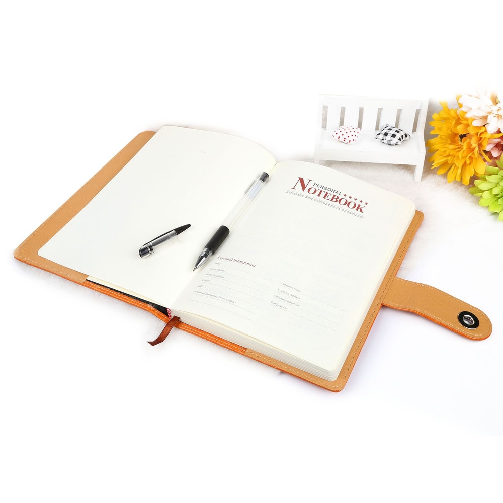 Open personal notebook with blank pages and black pen, featuring a stylish orange cover and a charming floral background.