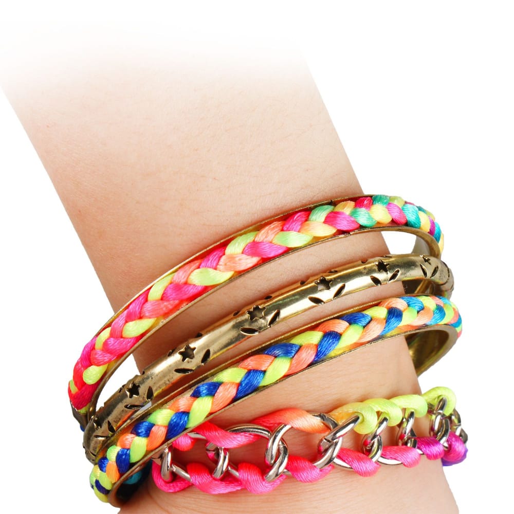 Colorful braided and metallic bangle bracelets stacked on a wrist, featuring vibrant pink, blue, and yellow designs for a trendy accessory look.