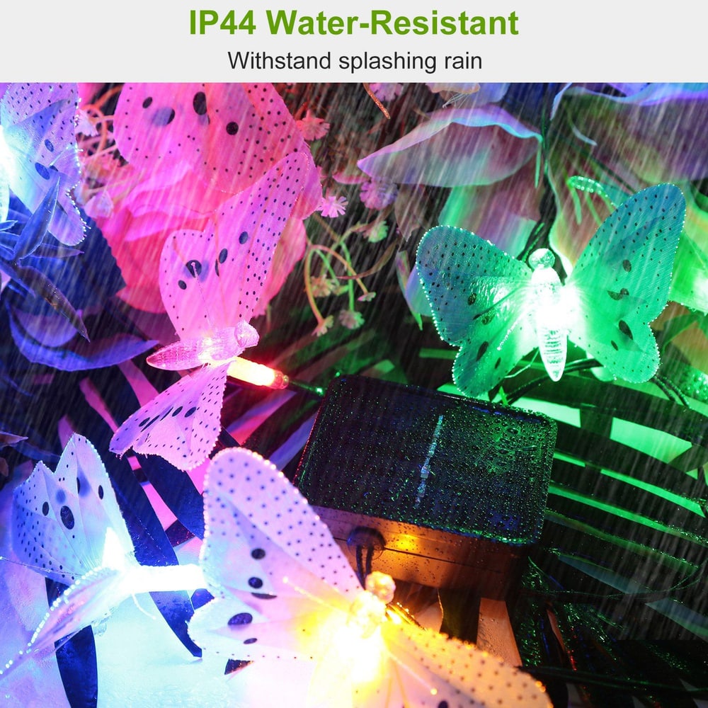 Colorful IP44 water-resistant butterfly string lights illuminated amidst rain, perfect for outdoor decoration and ambiance.