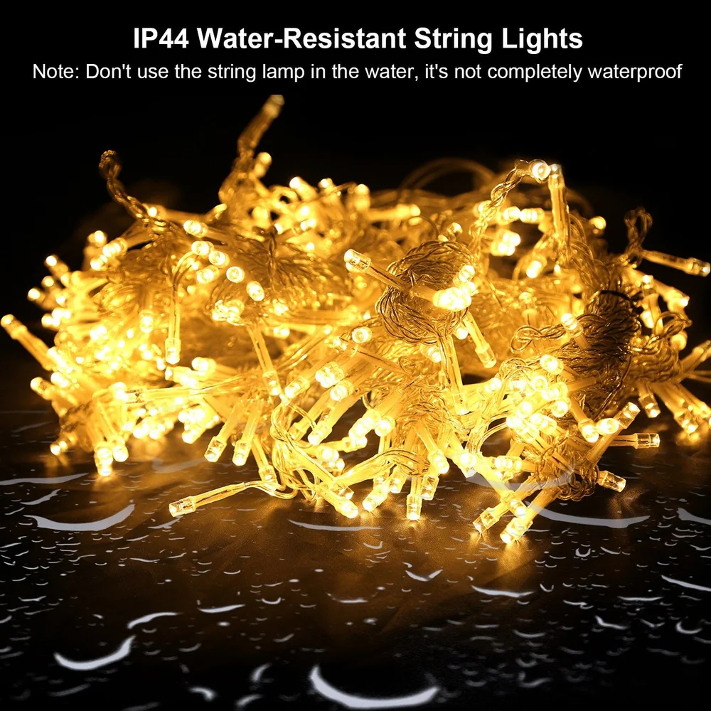 IP44 water-resistant string lights glowing warmly, featuring multiple LED bulbs on a delicate wire strand, set against a dark background with raindrop reflections, ideal for festive or outdoor decor.