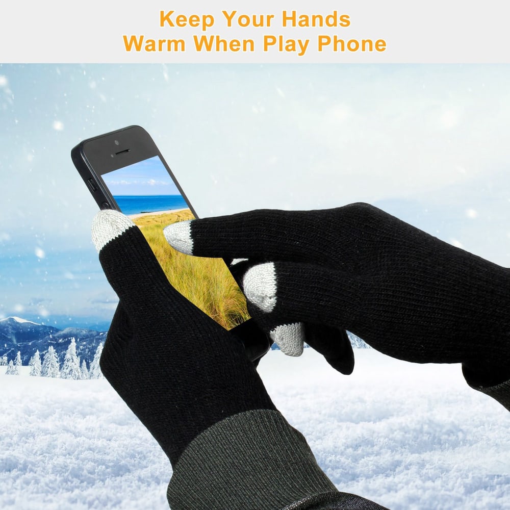 Warm touchscreen gloves being used to hold a smartphone while enjoying a winter scene in the background.